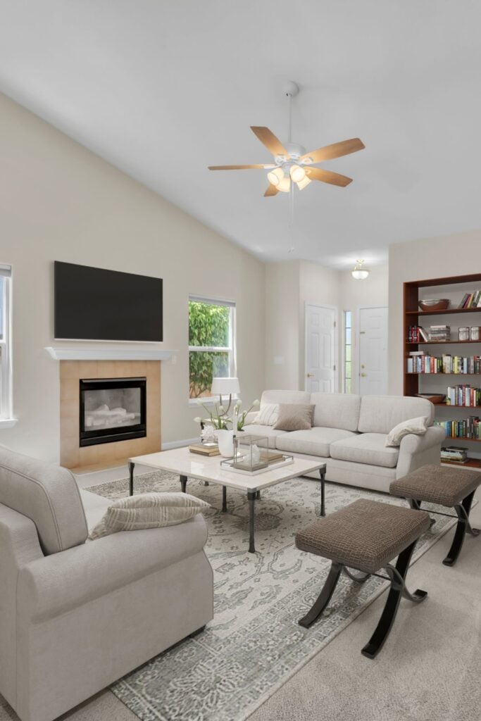 grey sofa and white sofa next to fireplace