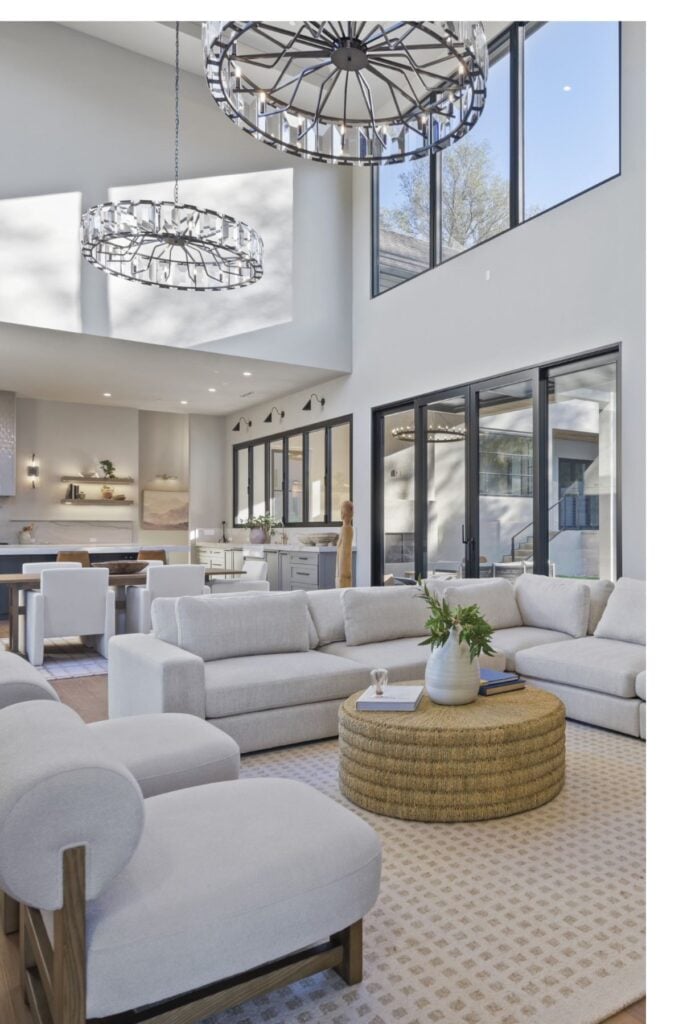 white sofas with two stories of windows